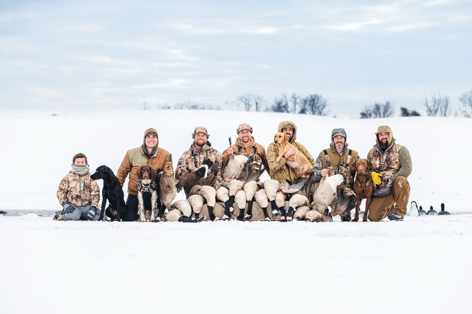 Hunters and dogs together after a winter field hunt